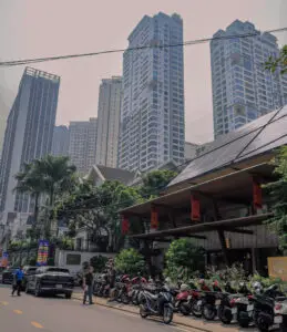 Apartment towers above street-level shops and parked motorbikes in Thảo Điền