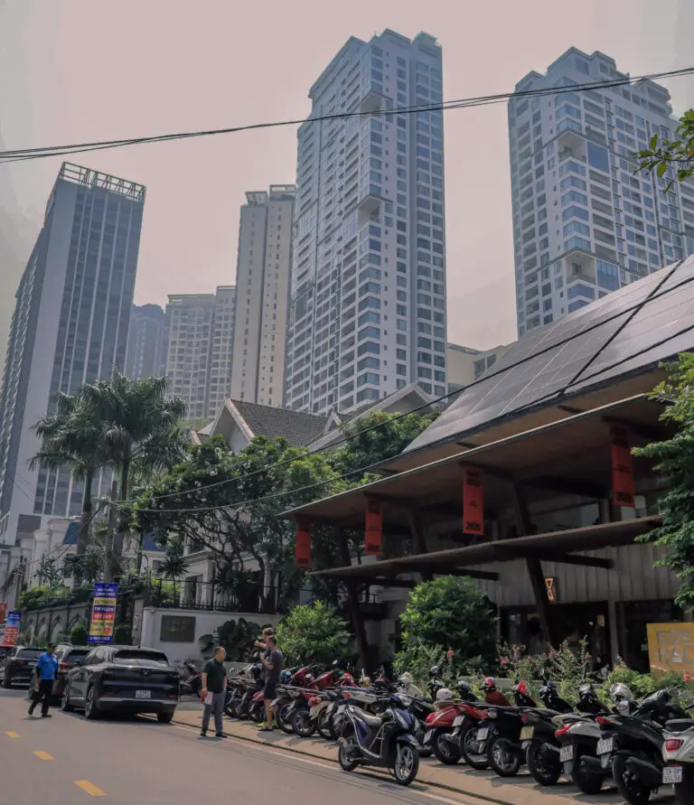 Apartment towers above street-level shops and parked motorbikes in Thảo Điền